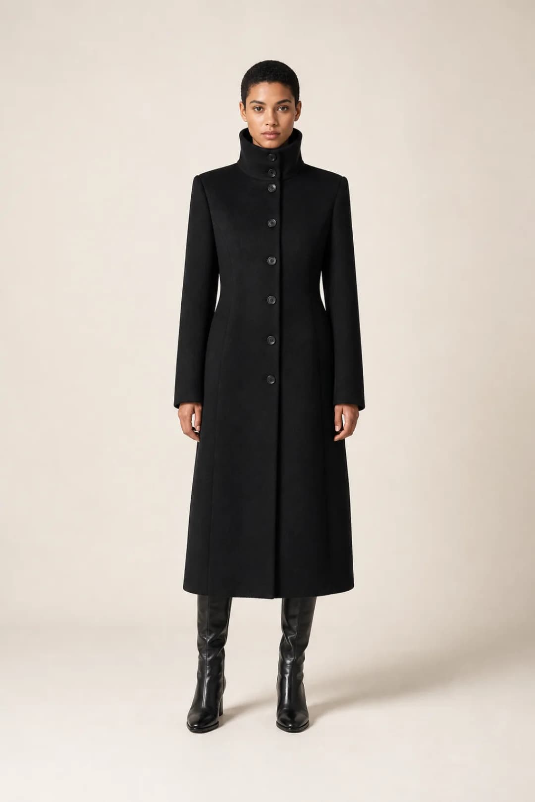Architectural wool coat on a model in a cream studio