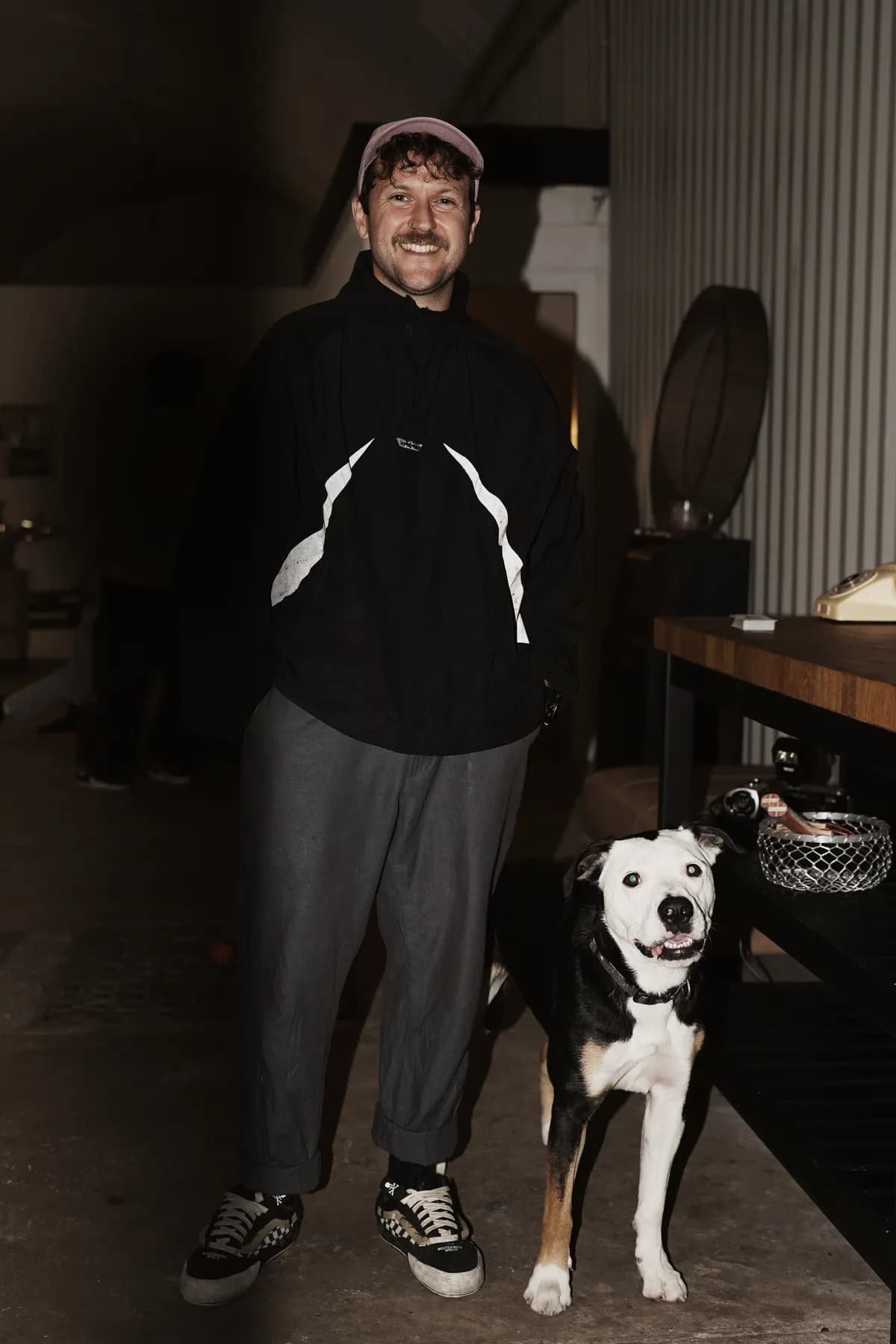 James, founder of OmniOps, standing with his dog